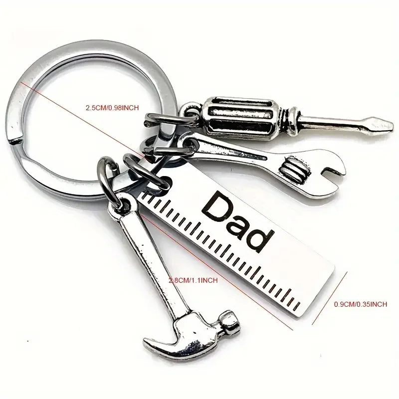 Silver multi-tool keychain set featuring a hammer and a knife, with a tag engraved 'Dad'.