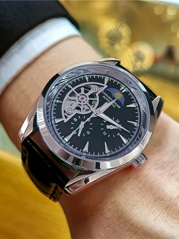 A close-up shot of a silver luxury automatic mechanical men's wristwatch on a person's wrist.