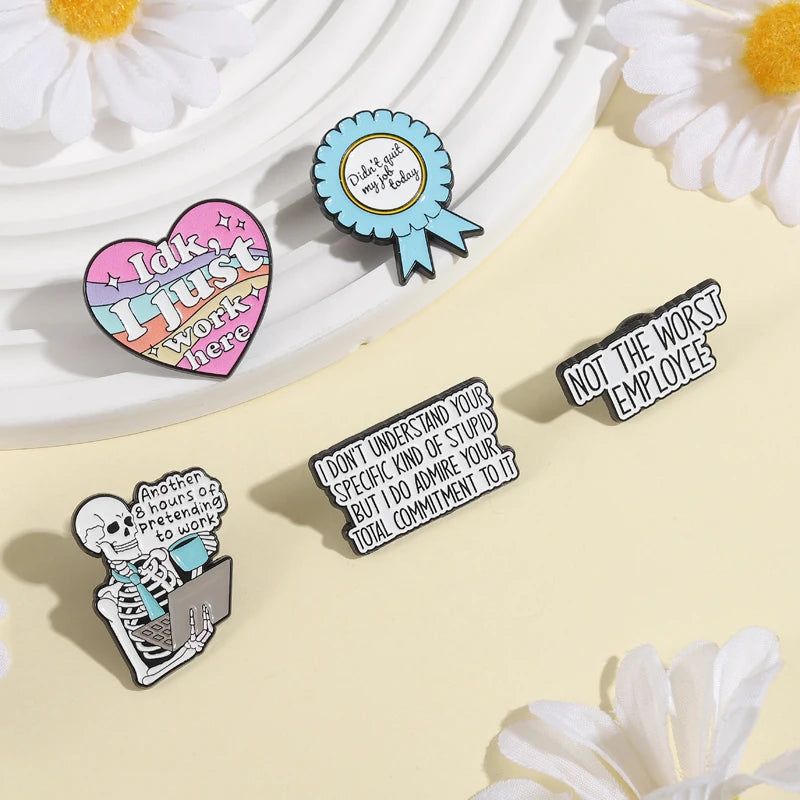 A collection of enamel pins featuring funny work quotes and a skull design on a light yellow background.