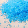 A pile of bright blue disposable rubber hair ties for kids scattered on a surface.