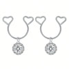 A pair of silver heart dangle non-piercing nipple rings adorned with cubic zirconia stones.