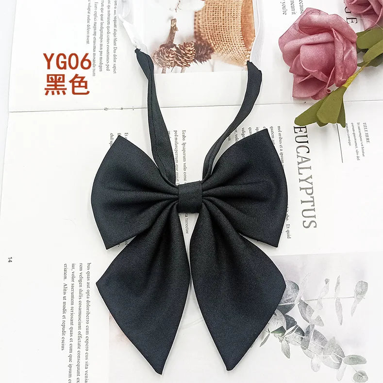 A black solid cotton bow tie displayed on a white background.