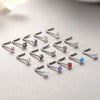 A collection of surgical stainless steel nose piercing studs in various gemstone colors and clear stones.
