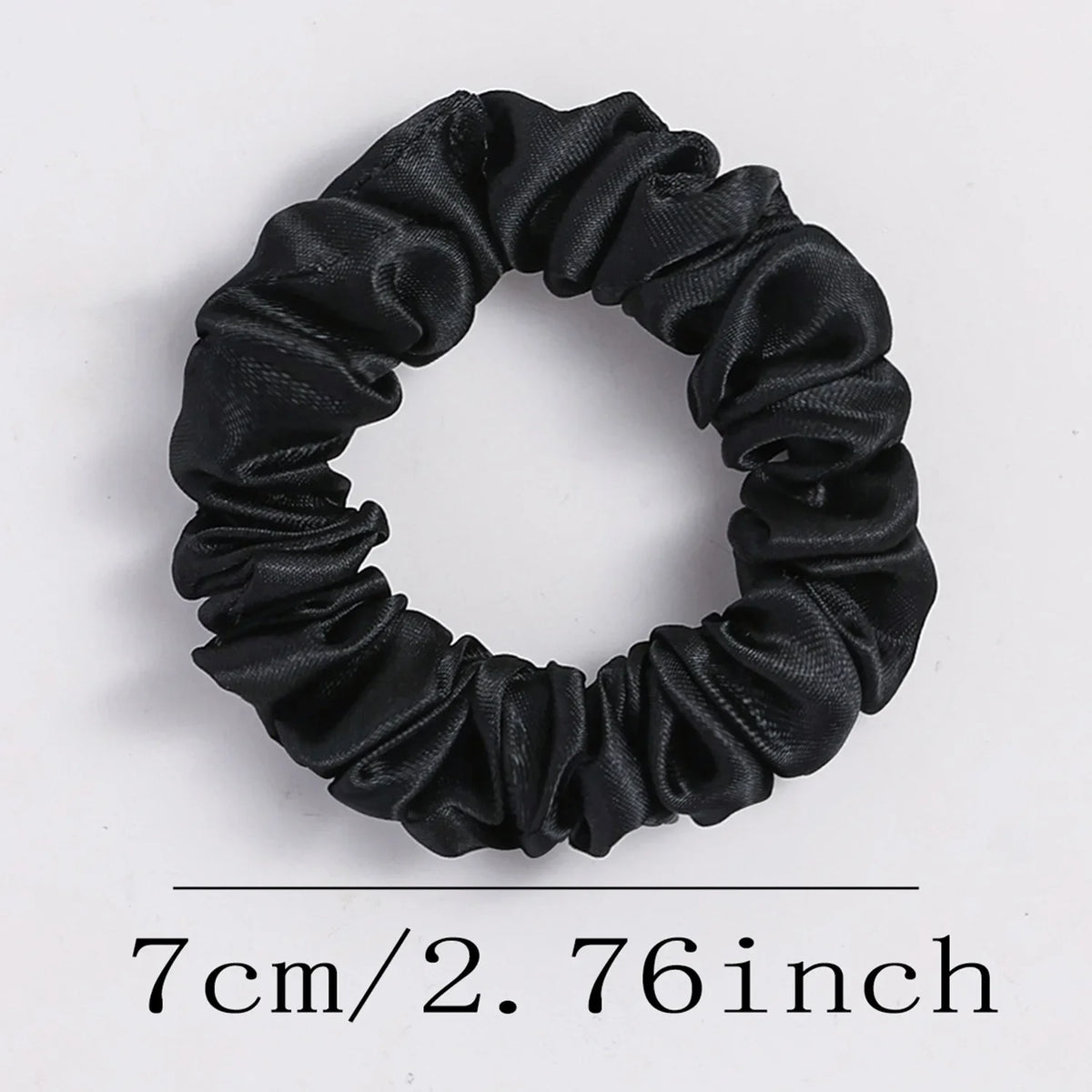 Black satin elastic hair ties coiled into a circular band