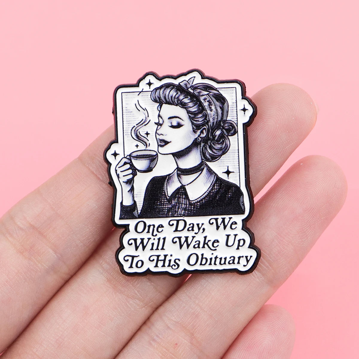 A black enamel pin featuring a stylized woman with hair in an updo holding a cup, with text reading One Day We Will Wake Up T