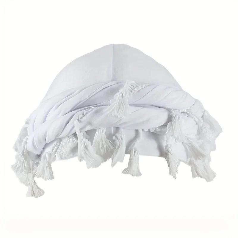 A white stretch modal and satin turban head wrap folded and draped.