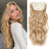 A close-up of long blonde hair with synthetic ombre clips attached to the strands.