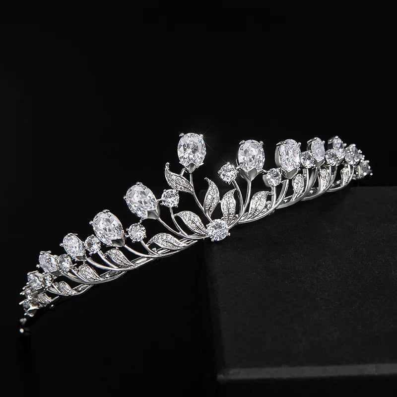A delicate silver bridal tiara headband adorned with sparkling cubic zirconia stones resembling leaves and flowers.