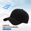 A black unisex cotton curved visor hat shown against a light blue sky background.