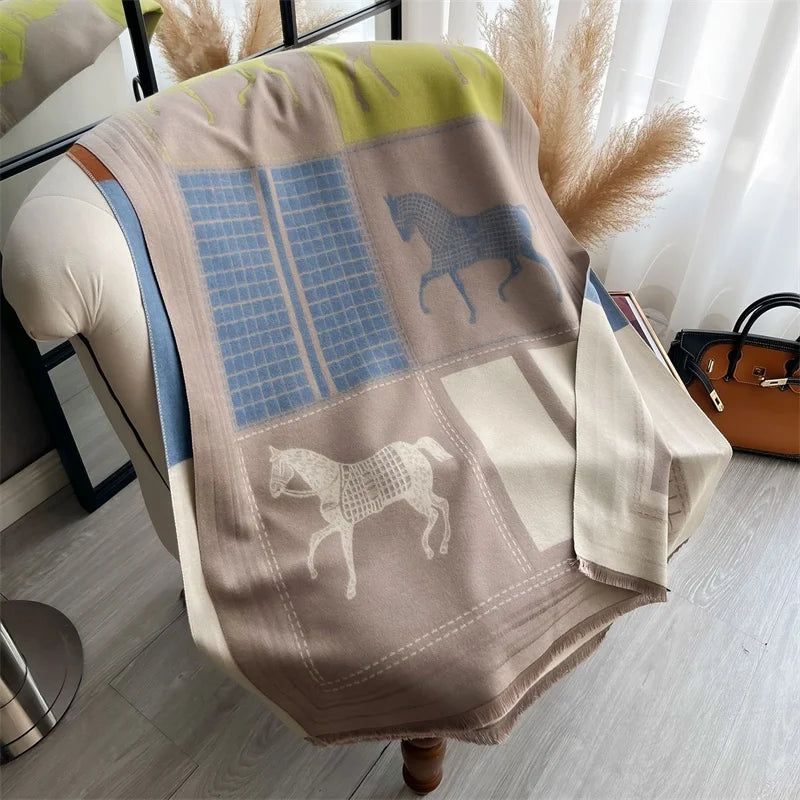 A beige and blue plaid cashmere feel scarf draped over a light-colored chair.