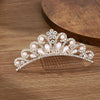A sparkling crystal princess tiara hair comb for women with pearl and diamond accents.