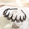 Black rhinestone butterfly hair clip accessory displayed on a white surface.