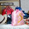 Pink satin drawstring storage bag for wigs and hair extensions displayed on a white surface.