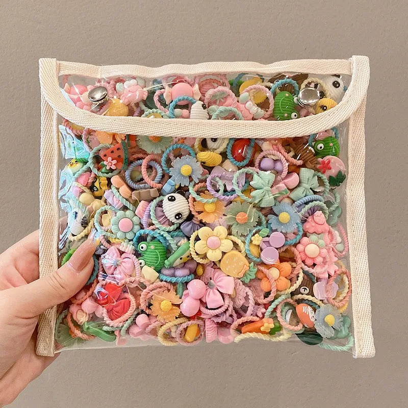 A hand holds a clear pouch filled with colorful decorative elastic hair bands for girls.