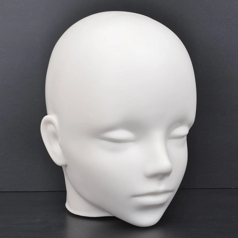 A white professional mannequin head used for practice and display.