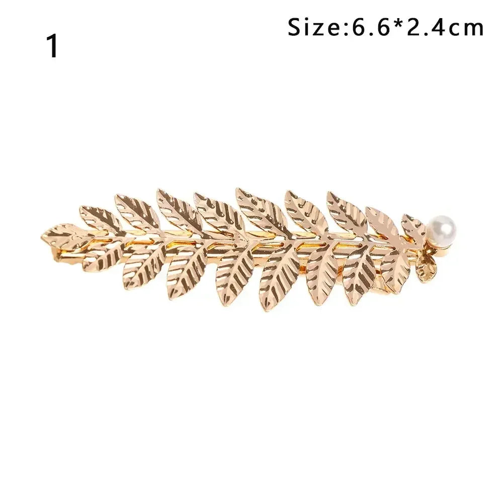 Gold leaf headband featuring delicate leaves and a pearl accent.