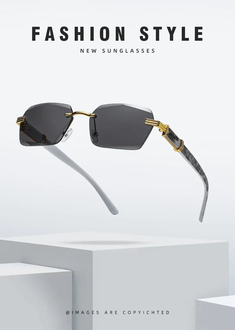 A pair of black gradient sunglasses with gold accents displayed on a white surface.