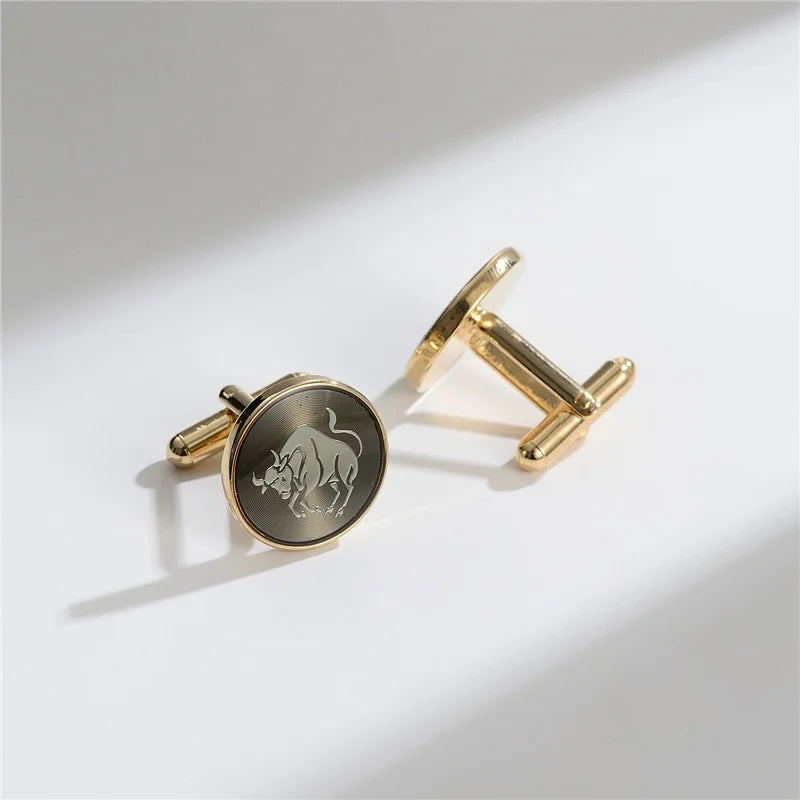 A pair of elegant gold cufflinks featuring a detailed silhouette of a bull's head on a dark background.