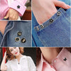 Close-up of elegant floral and geometric button brooch pins adorning denim fabric and pink clothing.