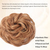 A close-up of a voluminous, textured brown hair bun hairstyle.