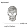 Broche de calavera de strass plateados con rasgos faciales detallados y forma redonda.