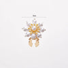 A floral button cufflink featuring white pearls and gold accents.