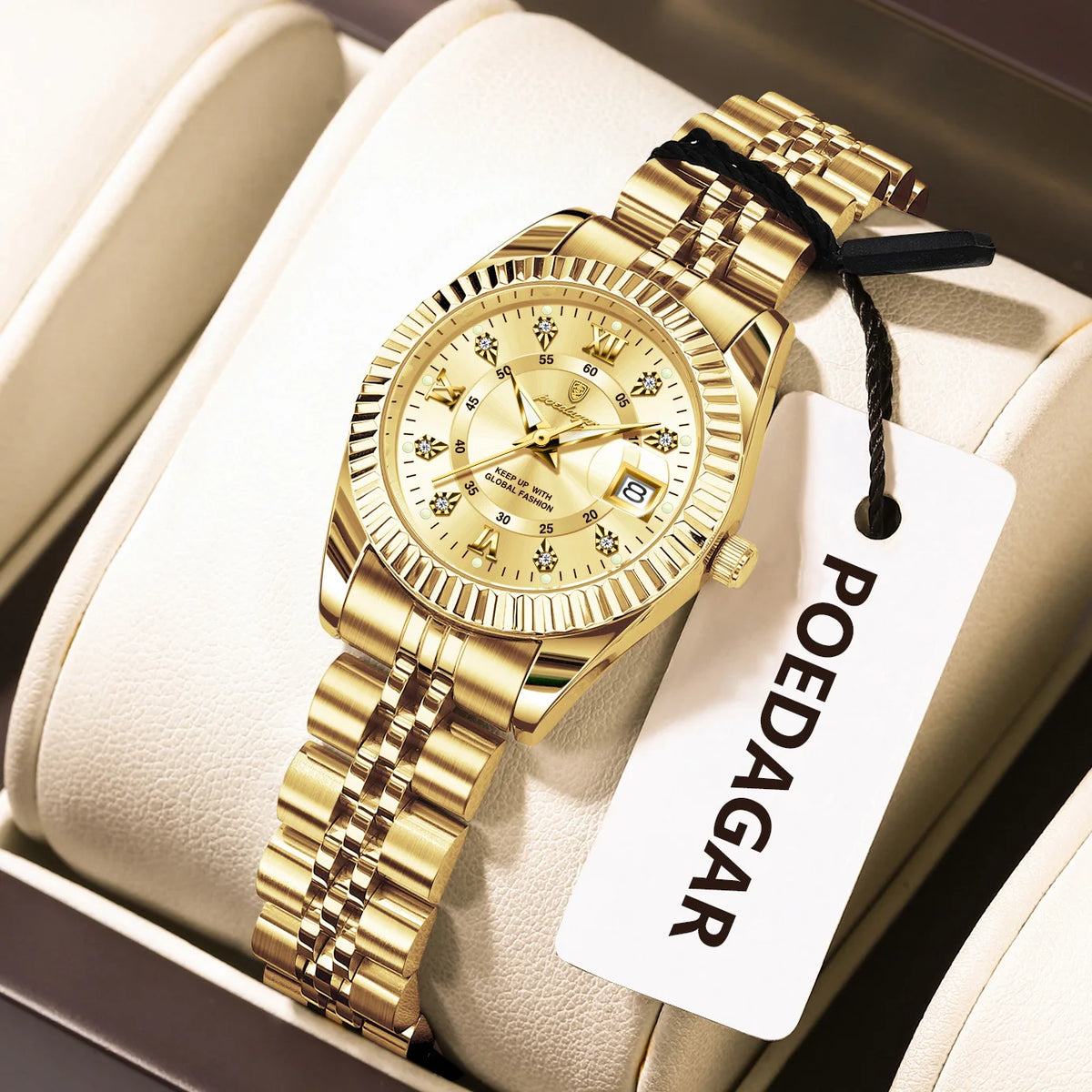 A gold-toned stainless steel quartz ladies wristwatch with a textured band is displayed in a light-colored box.