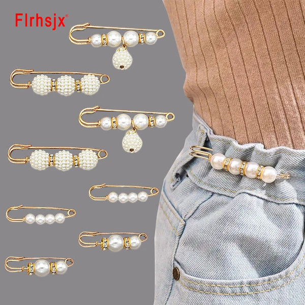 Various gold-toned metal pins featuring pearl and white bead designs for clothing