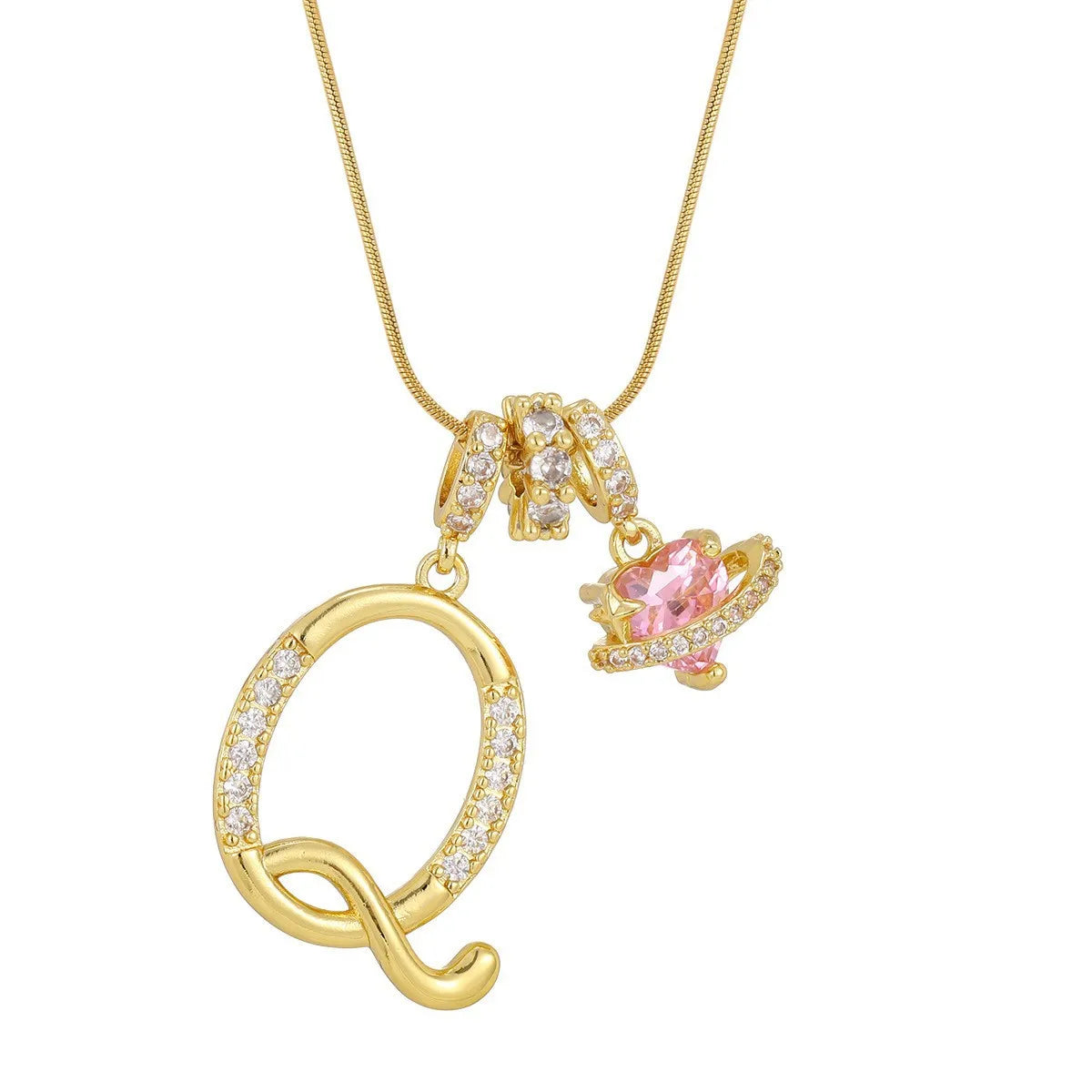 A gold letter pendant necklace featuring an initial charm and a pink gemstone.