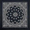 Black fabric with white paisley and floral mandala patterns printed on it.
