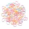 A pile of colorful elastic hair ties in pink, yellow, and light blue.