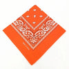 Orange cotton bandana scarf with white paisley print folded into a diamond shape