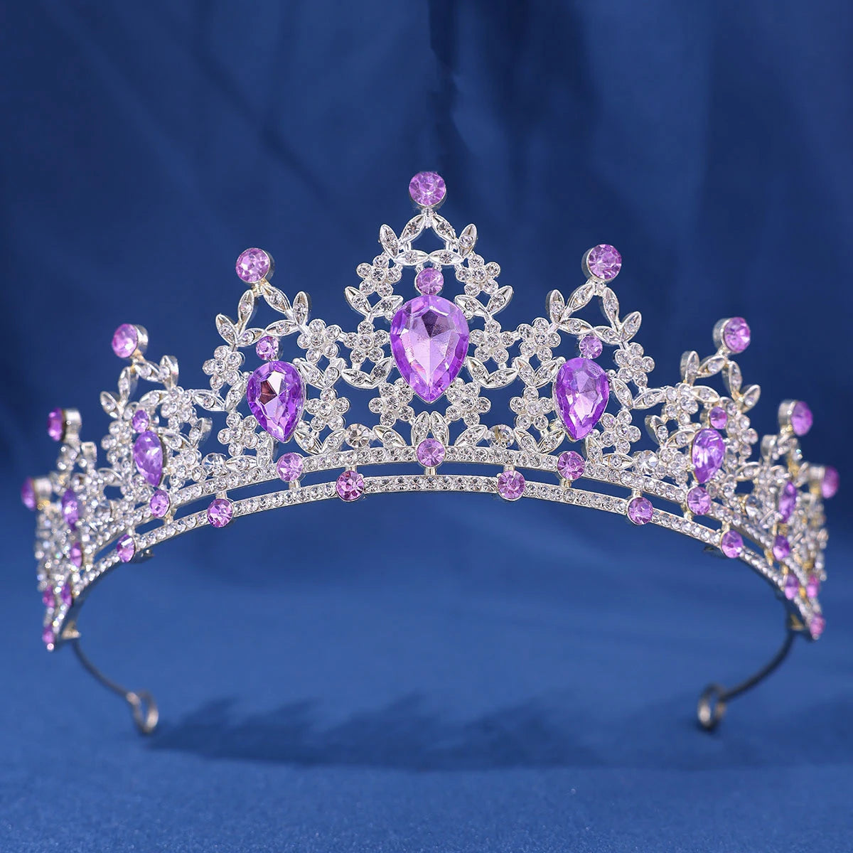 An elegant crystal rhinestone tiara and headband set featuring purple gemstones.