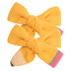 A set of cute yellow pencil bow hair clips.