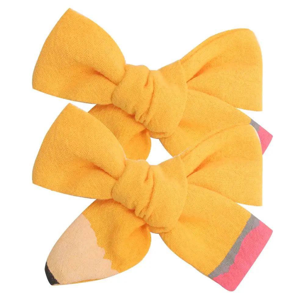 A set of cute yellow pencil bow hair clips.