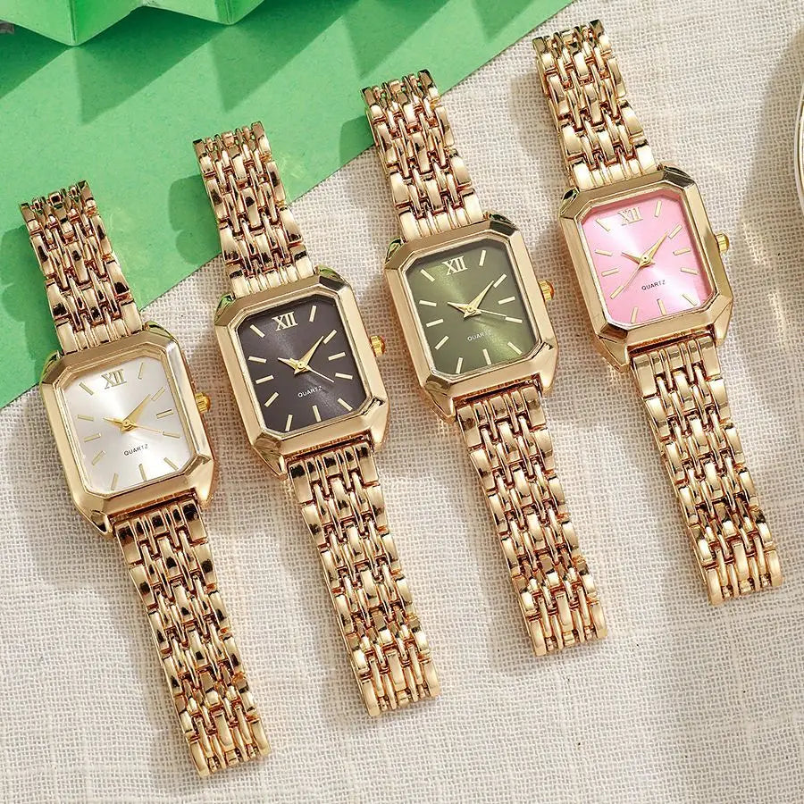 A collection of gold minimalist quartz watches with various colored dials and rose gold metal bracelets displayed on a light 