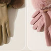 A pair of plush wrist gloves in olive green and dusty pink suede with faux fur trim.
