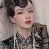 A close-up portrait of a woman wearing sheer lace fishnet evening gloves and traditional attire.