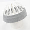 A gray knitted elastic headband with white slats is displayed on a white stand.