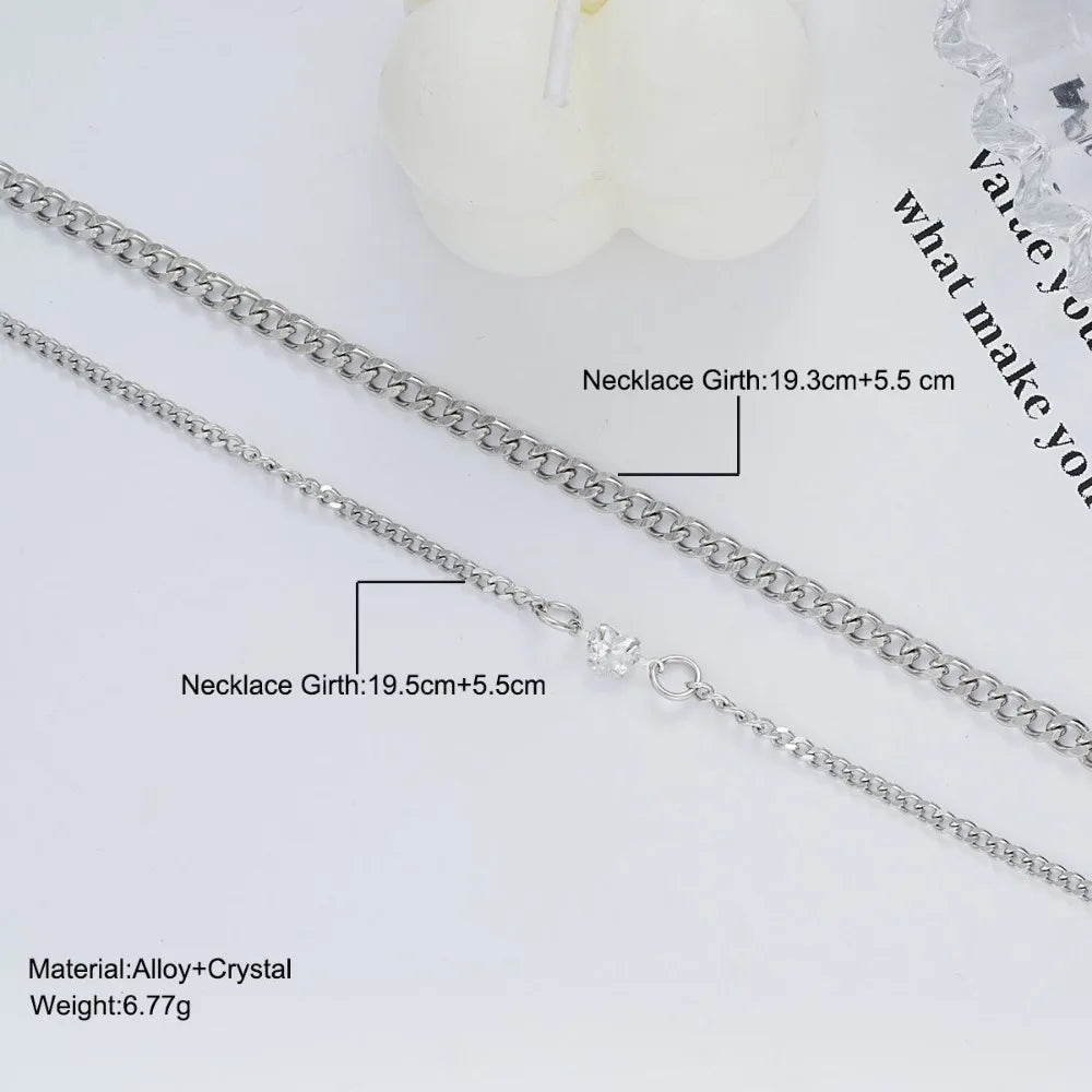 A set of dainty stainless steel heart link necklaces with a chain and crystal charm displayed on a white background.