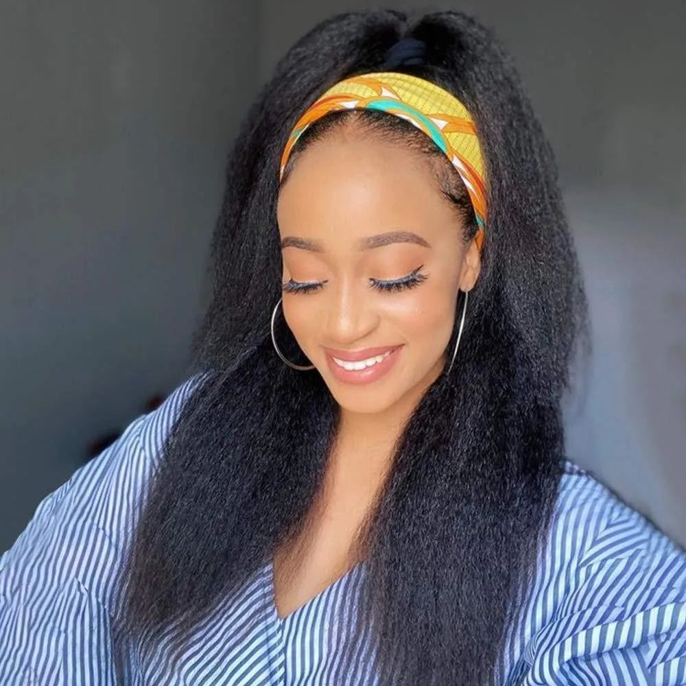 A woman with long black hair and a yellow patterned headband is looking down.