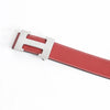 A red leather dress belt with a silver buckle shown diagonally.