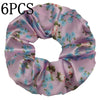 Seis gomas de tela satinada con estampado floral lavanda claro y flores azules y verdes.