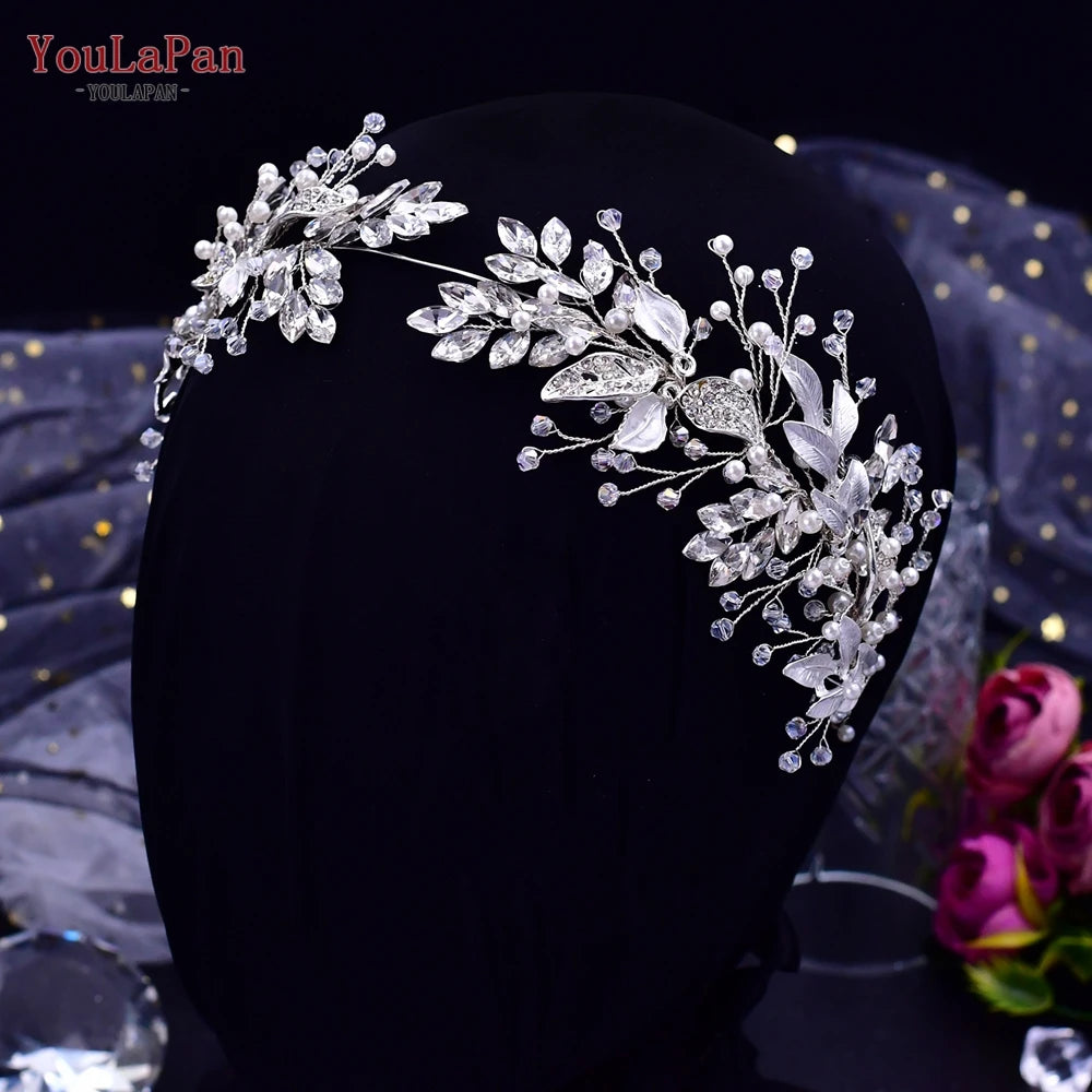 A close-up of a handmade crystal bridal headband displayed on a black mannequin.