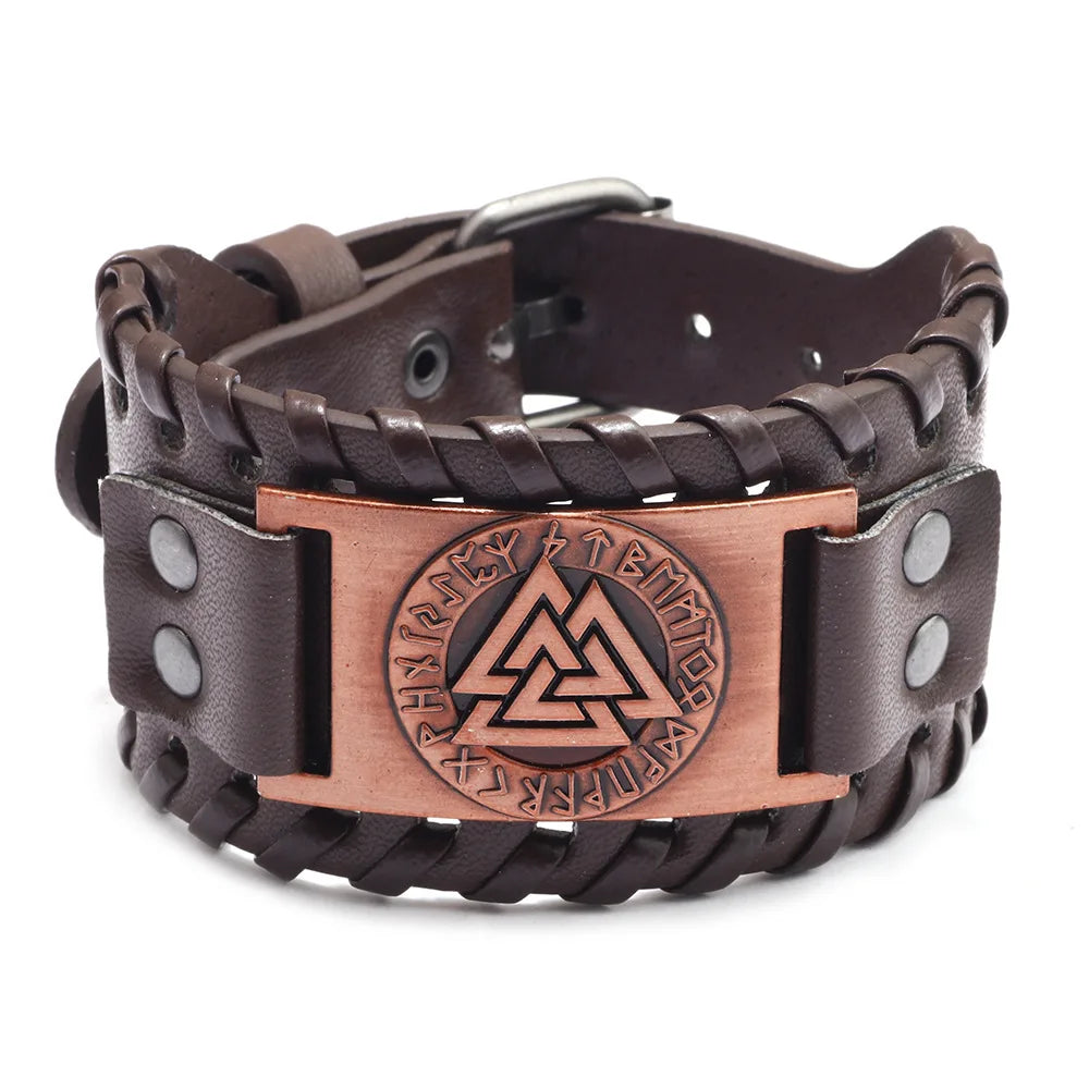 A dark brown leather bracelet with a bronze compass design and a buckle.
