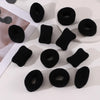 A collection of black cotton elastic hair ties in various sizes and shapes for ponytails and headbands.