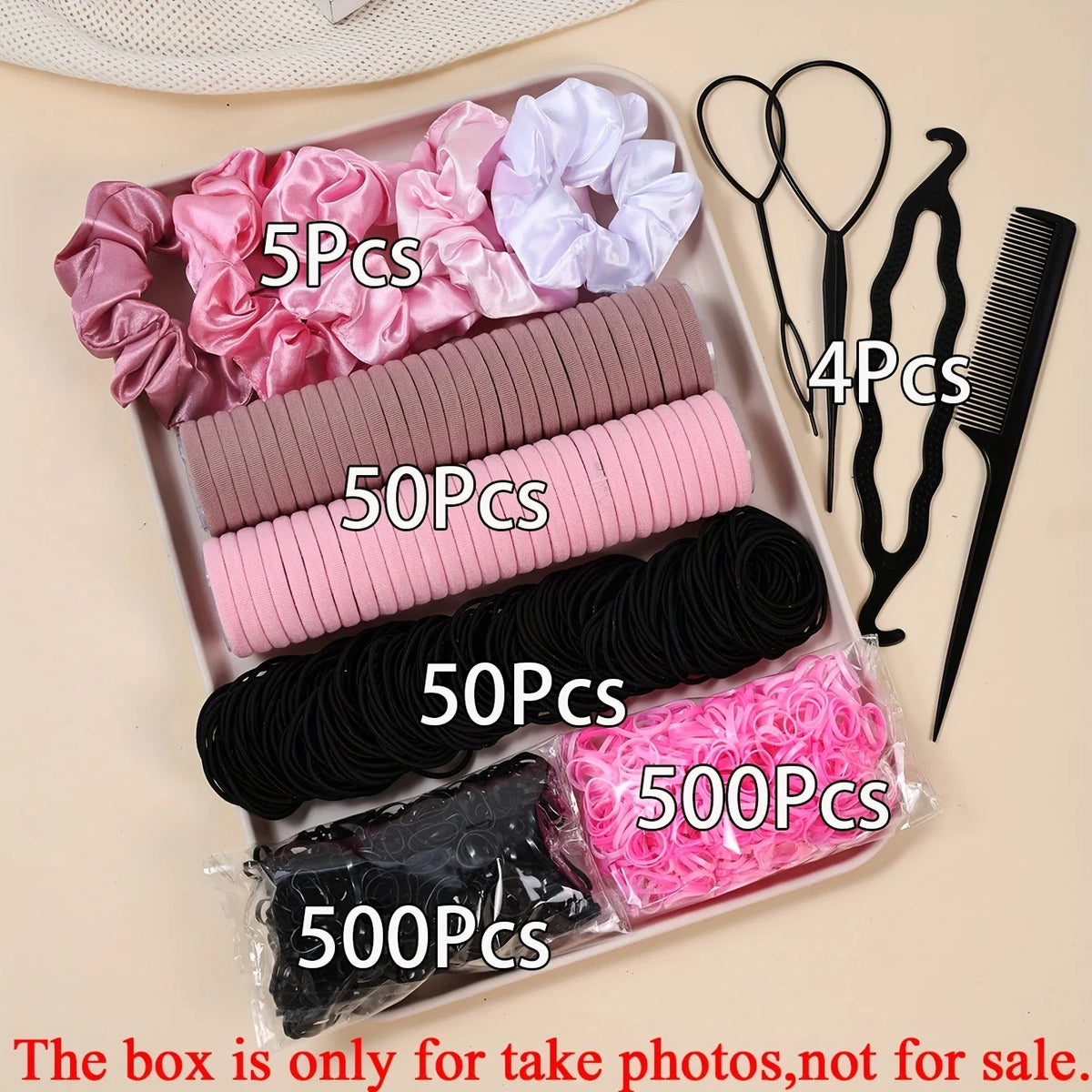 Une boîte contenant divers accessoires pour cheveux élastiques, incluant des mèches roses, violettes, noires et roses.