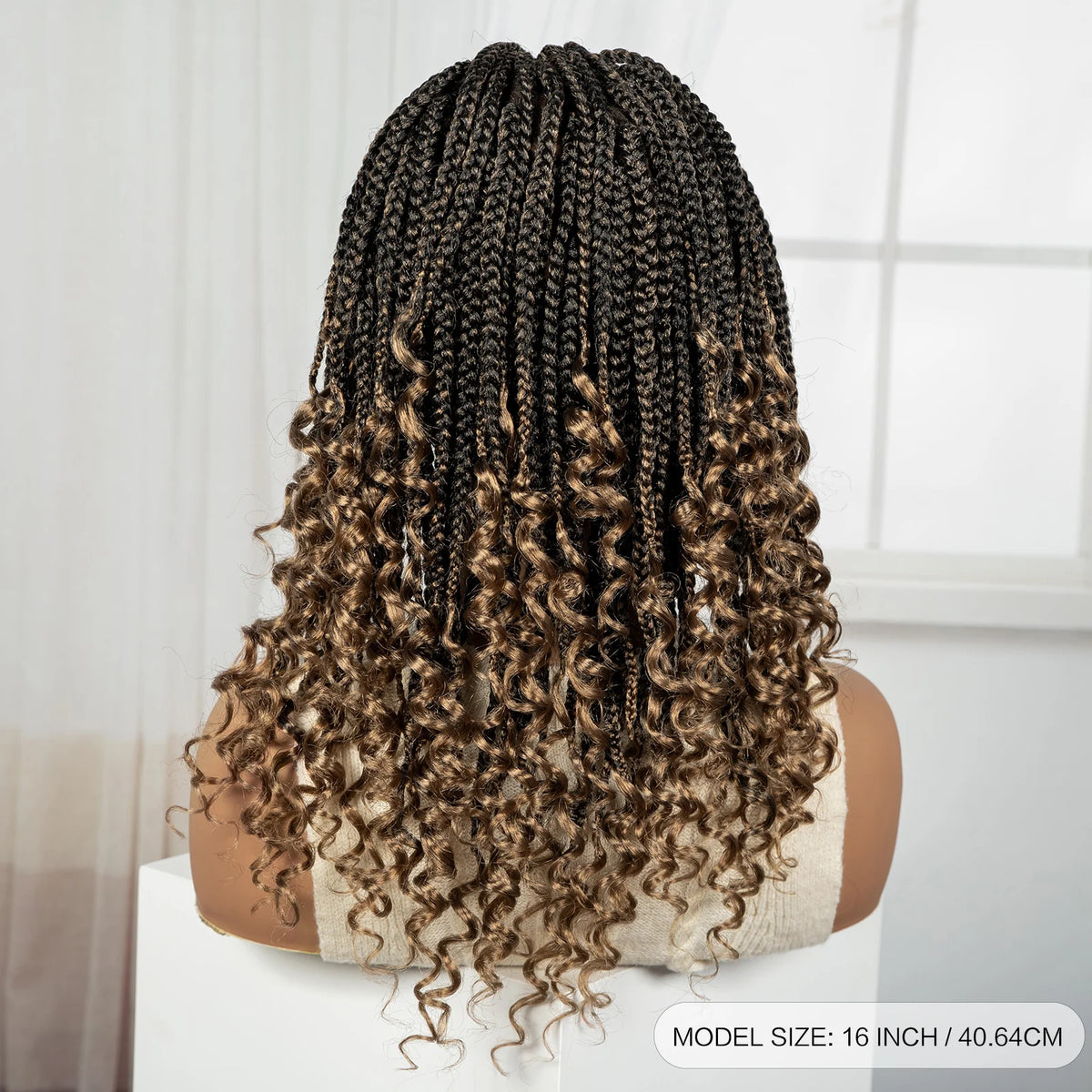 Back view of a long, curly brown box braid wig displayed on a white surface.