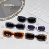 A collection of five polarized fashion sunglasses in various colors and styles displayed on a white surface.
