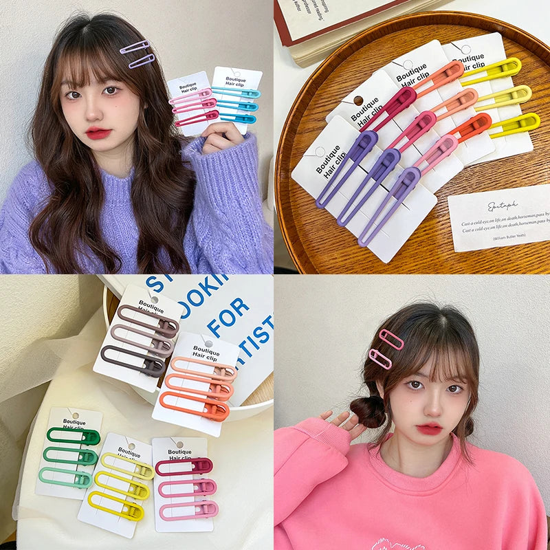 A collection of vintage frosted geometry hair clips in various colors displayed on a wooden tray.